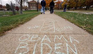 In this file photo: A chalk-written sign on a sidewalk gives directions to President Obama&#39;s grassroots event at Cornell College in Mount Vernon, Iowa, on Oct. 17, 2012. In January 2020, a free speech litigation group announced it is taking Iowa State University for, among other rules, a ban on sidewalk chalk. (Associated Press) **FILE**