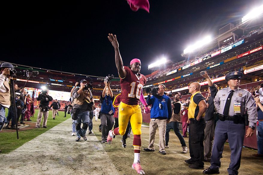 Washington Redskins quarterback Robert Griffin III (10) runs into the tunnel after winning 38 to 26 against the Minnesota Vikings, Landover, Md., Sunday, Oct. 14, 2012. (Craig Bisacre/The Washington Times)