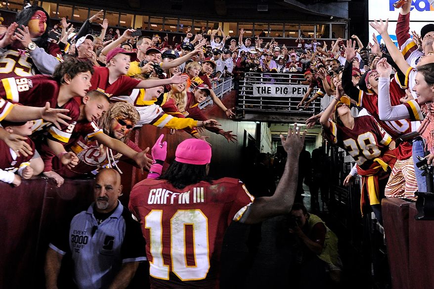 Washington Redskins quarterback Robert Griffin III (10) leaves the field after providing the Redskins their first home victory in nine games at FedEx Field, Landover, Md., Oct. 14, 2012. (Preston Keres/Special to The Washington Times)