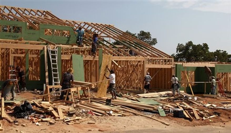 In this Friday, Sept. 21, 2012, photo, new homes are constructed in Edmond, Okla. U.S. builders started construction on single-family homes and apartments in September at the fastest rate since July 2008, a further indication that the housing recovery is strengthening. (AP Photo/Sue Ogrocki,)