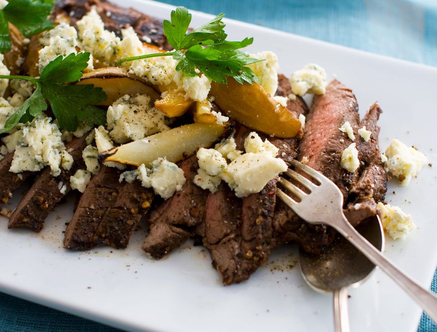 Sweet grilled pears and tangy blue cheese top this hearty grilled flank steak that has been flavored with a balsamic-pepper marinade. (Associated Press)