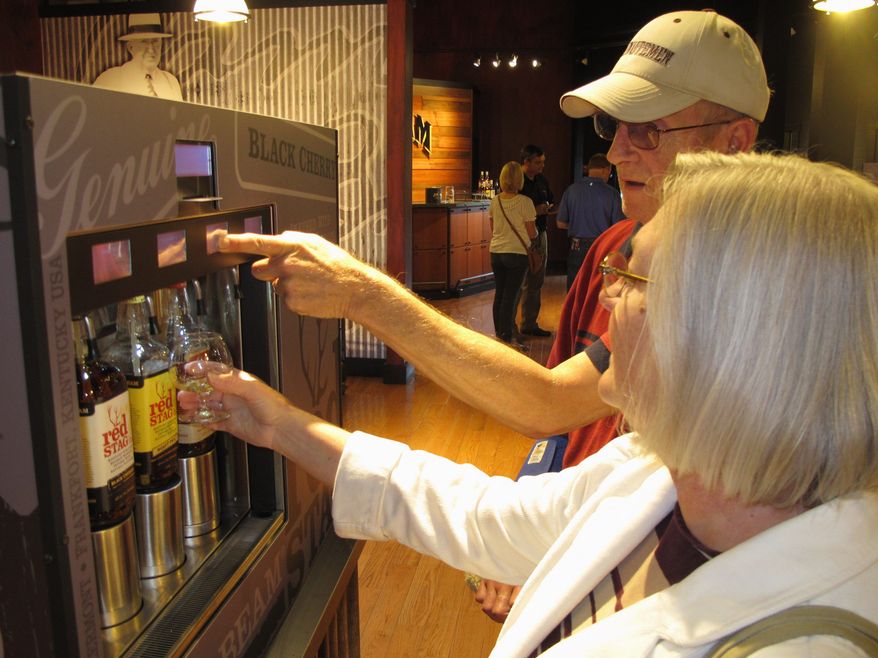 Sylvia Smith of Shelburne, Mass., and her husband, William, make selections at Jim Beam’s new visitors center in Clermont, Ky. The center is at the distillery, which is open for tours. (Associated Press)
