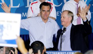 **FILE** Golf legend Jack Nicklaus (right) welcomes Republican presidential candidate Mitt Romney to the stage during a campaign rally on Sept. 26, 2012, in Westerville, Ohio. (Associated Press)