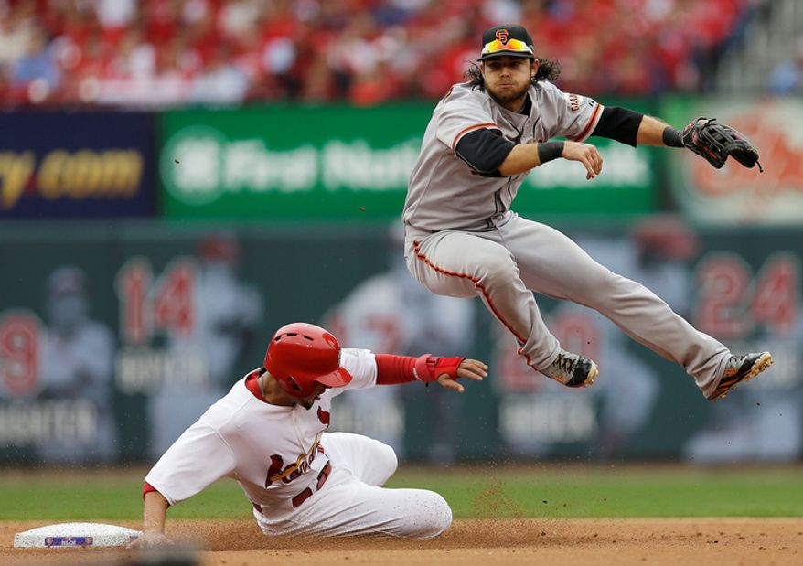 San Francisco Giants shortstop Brandon Crawford (35) throws to first base for a double play as St. Louis Cardinals' Jon Jay (19) slides to second and Carlos Beltran (3) at first are out during the second inning of Game 3 of baseball's National League championship series Wednesday, Oct. 17, 2012, in St. Louis. (AP Photo/David J. Phillip)