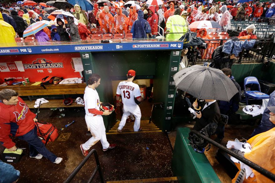 St. Louis Cardinals players leave the dugout during a rain delay of Game 3 of baseball's National League championship series against the San Francisco Giants, Wednesday, Oct. 17, 2012, in St. Louis. (AP Photo/David J. Phillip)