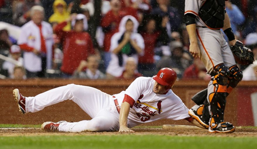 St. Louis Cardinals' David Freese (23) slides to score a run on a hit by Daniel Descalso (33) during the seventh inning of Game 3 of baseball's National League championship series against the San Francisco Giants, Wednesday, Oct. 17, 2012, in St. Louis. (AP Photo/David J. Phillip)
