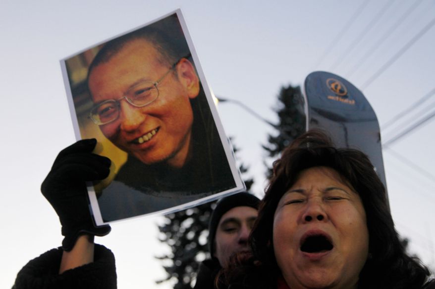Protestos scream for the freedom of Nobel peace laureate Liu Xiaobo Thursday Dec. 9, 2010 outside te Chinese Embassy in Oslo, Norway. A day before the Nobel committee honors Liu, an imprisoned Chinese dissident with its peace prize, China ratched up the rhetoric calling the award "an interference" in its internal affairs. (AP Photo/John McConnico)