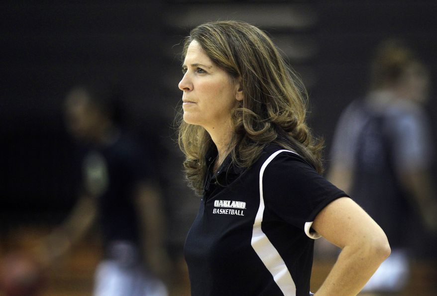 In a photo from Oct. 16, 2012, Oakland University women's basketball coach Beckie Francis looks over her team's practice in Rochester, Mich. Francis tells The Associated Press she was sexually assaulted by her dad, who is now deceased, from the age of 4 until she was in the seventh grade. The 47-year-old coach has decided to speak out against the problem in part because of the Jerry Sandusky scandal at Penn State. (AP Photo/Carlos Osorio)