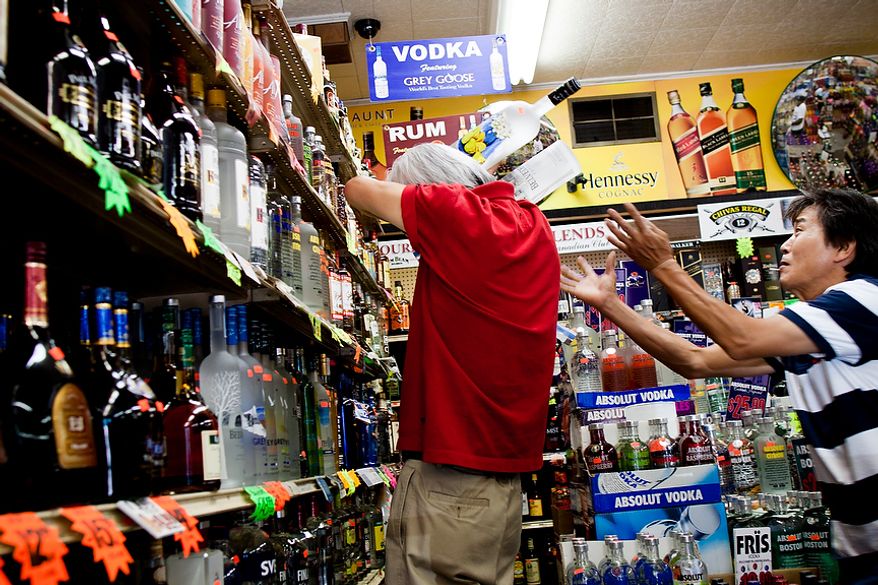 Sung Kim, right, employee at Sammy's Liquor in Northeast Washington, D.C., gives support to store owner, Dae Yoon, as he tries to re-rack several glass bottles of liquor that were dislodged during a 5.9 magnitude earthquake in the District on Tuesday, August 23, 2011. (Pratik Shah/The Washington Times)