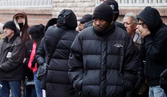 **FILE** People wait in line to enter the Northern Brooklyn Food Stamp and DeKalb Job Center in New York on Feb. 24, 2012. (Associated Press)