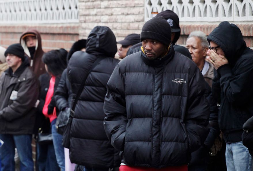 **FILE** People wait in line to enter the Northern Brooklyn Food Stamp and DeKalb Job Center in New York on Feb. 24, 2012. (Associated Press)