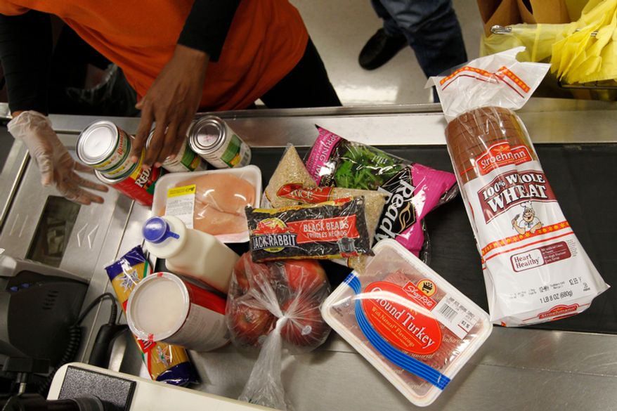 Mayor Michael Nutter's purchases are scanned by a cashier at a ShopRite grocery story Monday, April 23, 2012, in Philadelphia. Nutter pledged Monday to live on the average food stamp benefit of five dollars a day for the entire week. The challenge takes place the week before the planned asset test for food stamps goes into effect in Pennsylvania, which critics say will disqualify thousands of low-income families from food assistance. (AP Photo/Matt Rourke)