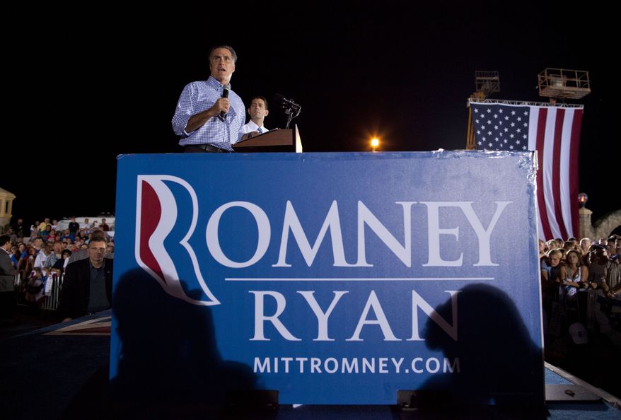 ** FILE ** Republican presidential candidate, former Massachusetts Gov. Mitt Romney, left, speaks as vice presidential running mate Rep. Paul Ryan, R-Wis., watches during a campaign rally on Friday, Oct. 19, 2012 in Daytona Beach, Fla. (AP Photo/ Evan Vucci)