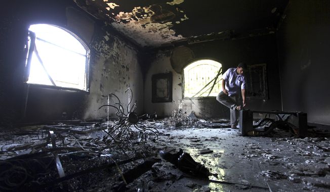 ** FILE ** A Libyan man investigates the inside of the U.S. Consulate in Benghazi, Libya, on Sept. 13, 2012, after an attack two days earlier that killed four Americans, including Ambassador J. Christopher Stevens. (Associated Press)