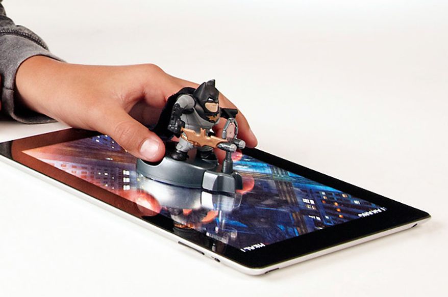 Use two fingers on the display base to have the Caped Crusader action figure interact with the iPad game using the Apptivity Batman: The Dark Knight Rises starter set.