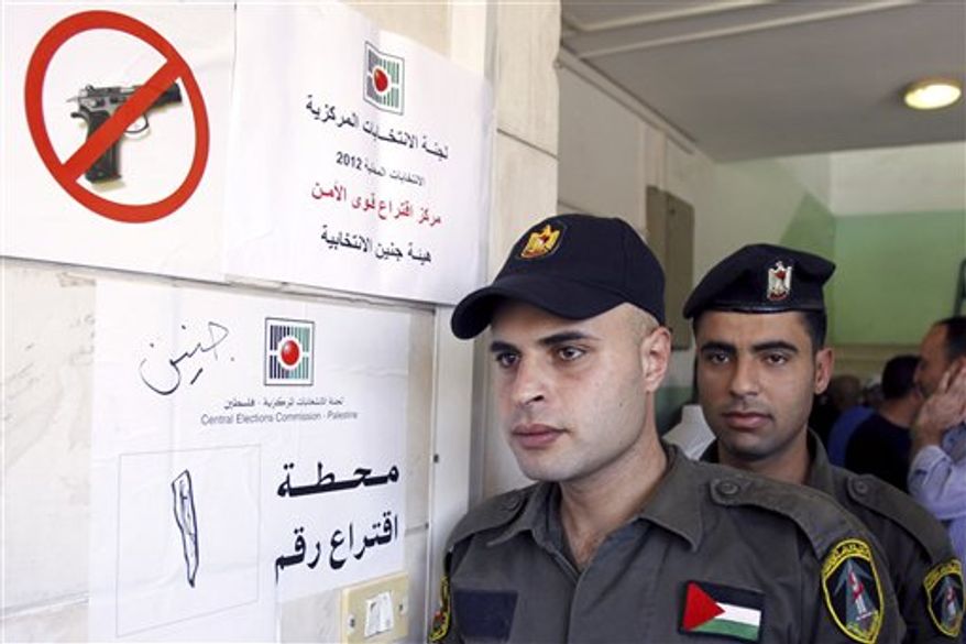 ** FILE ** Palestinian security officers wait to cast their early votes during local elections at a polling station in the West Bank town of Jenin, Thursday, Oct. 18, 2012. They cast an early vote ahead of local elections that are to take place across the West Bank on Oct. 20, 2012, in the first such polls since 2006. (AP Photo/Mohammed Ballas)