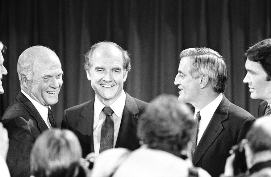 In this Oct. 13, 1983 file photo, Presidential hopefuls, Sen. John Glenn, left, former Sen. George McGovern, center, and former Vice-President Walter Mondale, right, pause for photographers after debating the nuclear arms issue at the Kennedy School of Government at Harvard University in Cambridge, Mass. A family spokesman says, McGovern, the Democrat who lost to President Richard Nixon in 1972 in a historic landslide, has died at the age of 90. (AP Photo/Elise Amendola, File)
