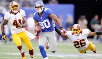 New York Giants wide receiver Victor Cruz’s 77-yard touchdown Sunday, with Madieu Williams (41) and Josh Wilson in his wake, was one of seven pass plays covering at least 40 yards the Redskins have surrendered this season. Washington allowed just nine such plays in all of the 2011 season. (Preston Keres/Special to The Washington Times) 