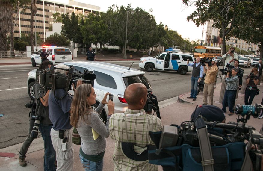 U.S. marshals block the street as agents drive away in a vehicle believed to be carrying Nakoula Basseley Nakoula after his arraignment in federal court in Los Angeles Thursday, Sept. 27, 2012. A federal judge on Thursday ordered Nakoula, the man behind a crudely produced anti-Islamic video that inflamed parts of the Middle East to be detained because he is a flight risk and violated terms of his probation. (AP Photo/Damian Dovarganes)