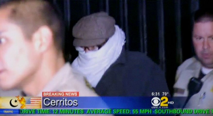 ** FILE ** Nakoula Basseley Nakoula, the man behind the anti-Muslim movie that inflamed the Middle East, is escorted by Los Angeles County sheriff's deputies from his home early on Saturday, Sept. 15, 2012, in Cerritos, Calif. (AP Photo/CBS2-KCAL9)