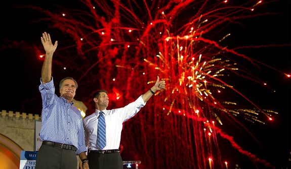 Republican presidential candidate, former Massachusetts Gov. Mitt Romney, left, and vice presidential running mate Rep. Paul Ryan, R-Wis., wave to the crowd as fireworks go off during a campaign rally on Friday, Oct. 19, 2012 in Daytona Beach, Fla.  (AP Photo/ Evan Vucci)