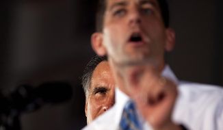 Republican presidential candidate, former Massachusetts Gov. Mitt Romney, rear left, watches vice presidential running mate Rep. Paul Ryan, R-Wis., speak during a campaign rally on Friday, Oct. 19, 2012 in Daytona Beach, Fla.  (AP Photo/ Evan Vucci) **FILE**