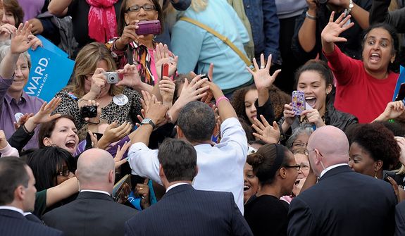 President Barack Obama is surrounded by Secret Service agents as he greets women who were on the riser behind him, after he spoke about choice facing women in the election during a campaign event at George Mason University, in Fairfax, Va., Friday, Oct. 19, 2012. (AP Photo/Susan Walsh)