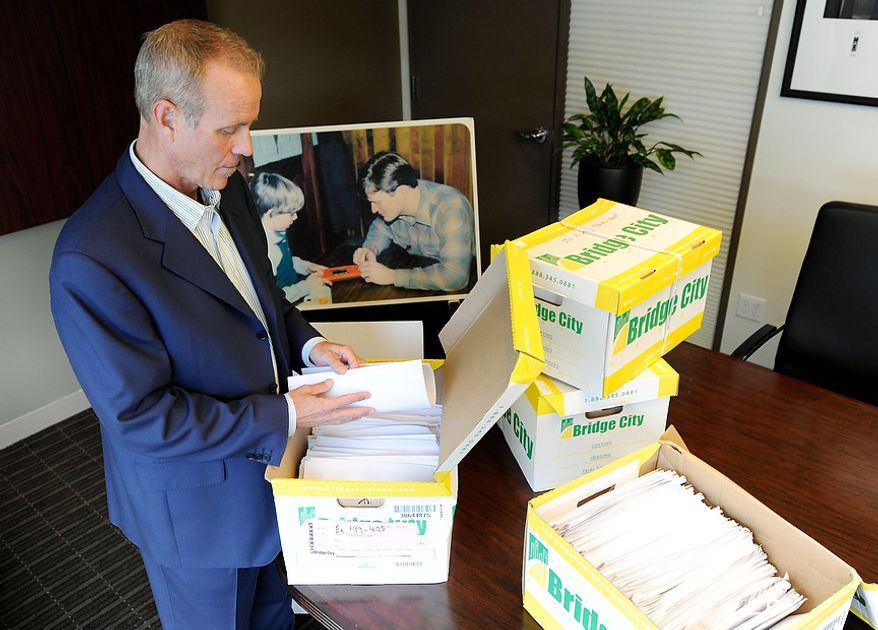 Portland attorney Kelly Clark examines Oct., 16, 2012, in his office in Portland, Ore., some of the 14,500 pages of previously confidential documents created by the Boy Scouts of America concerning child sexual abuse within the organization. The documents were released two days later, despite The Boy Scouts of America's fight to keep those files confidential. (Associated Press)