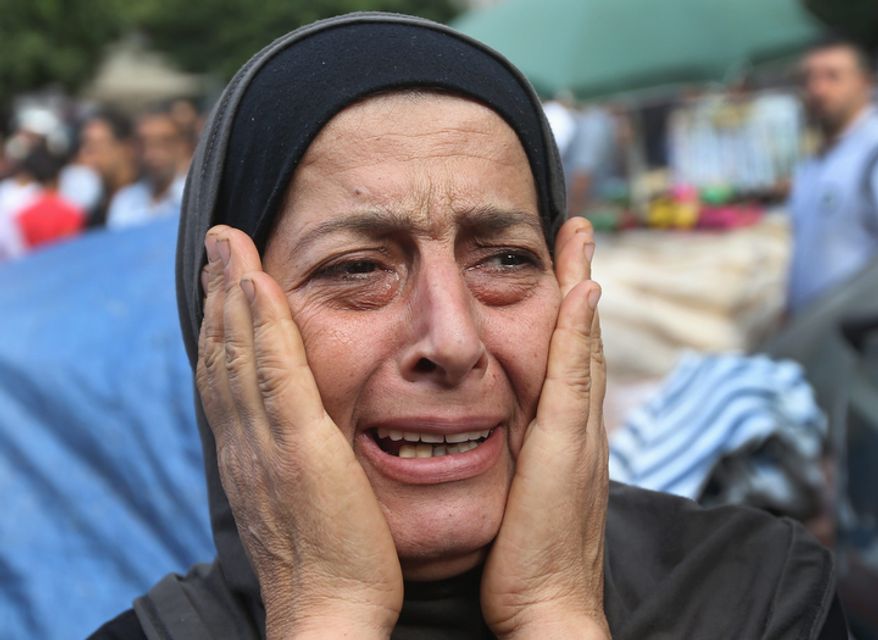 A Lebanese woman mourns Oct. 23, 2012, in the Sunni neighborhood of Tarik al-Jadida in Beirut during the funeral procession of Palestinian Ahmad Queider, 20, who was killed the previous day during exchange of gunfire between Lebanese troops and gunmen as he rode his motorcycle. (Associated Press)