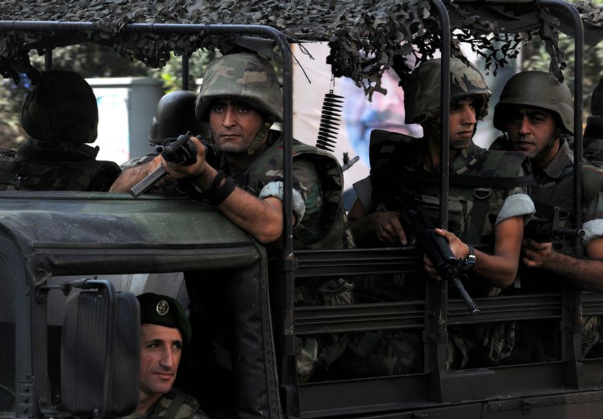 Lebanese Army soldiers patrol a neighborhood after overnight clashes between Sunni and Shiite gunmen in Beirut on Oct. 22, 2012. (Associated Press)