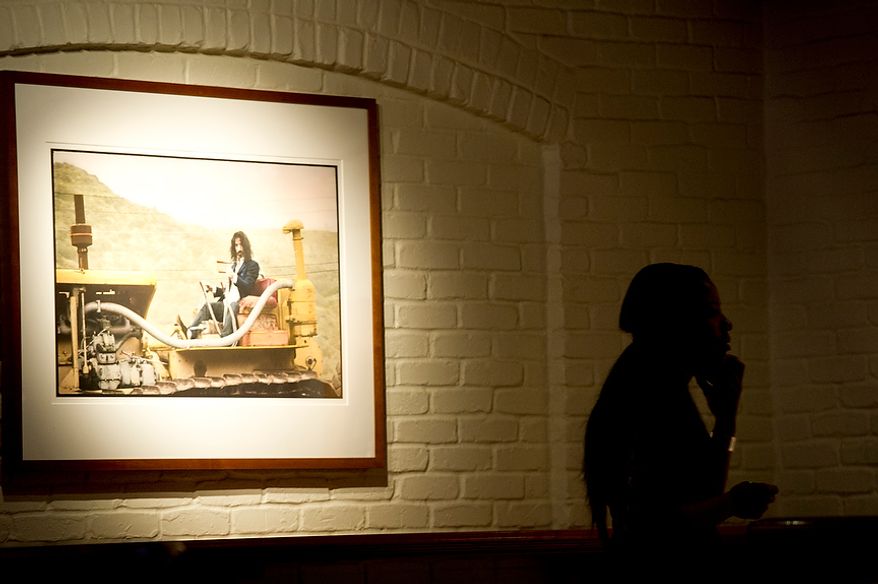 Integriti Reeves, artist-in-residence at the DC Jazz Festival Education Program, looks at artwork on the walls at Hamilton Live in Washington, D.C. while waiting to perform at the National Cherry Blossom Festival launch luncheon on Tuesday, Oct. 23, 2012. Mayor Vincent Gray also spoke, and former American Idol contestant and recording artist Elliott Yamin, who is one of the 2013 festival celebrity ambassadors, performed as well. (Barbara L. Salisbury/The Washington Times)