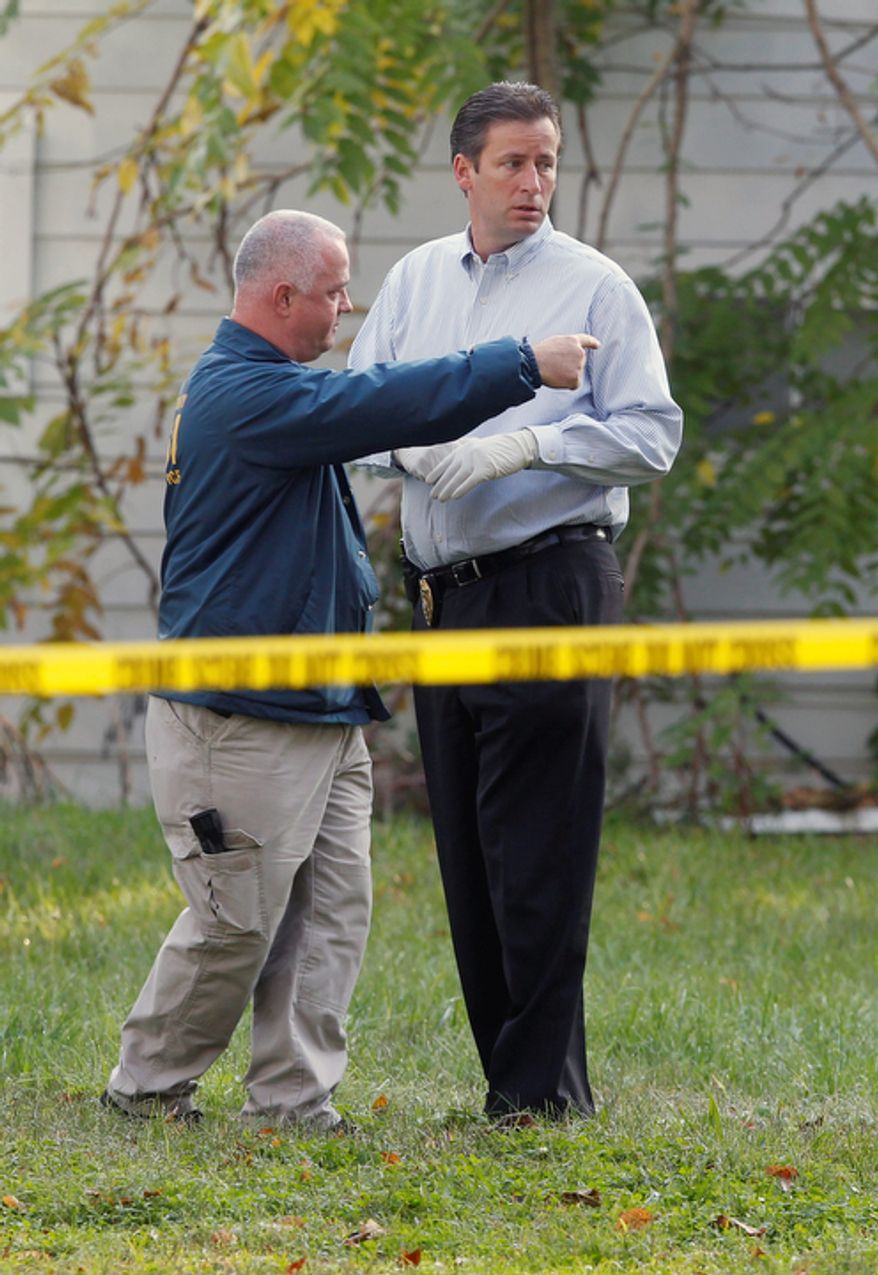 Investigators look in the rear yard of a home Tuesday, Oct. 23, 2012, in Clayton, N.J., after a body preliminarily identified as a missing 12-year-old girl's was found in a home's recycling bin. The Gloucester County Prosecutor's Office announced early Tuesday that they believed the body of Autumn Pasquale was found around 10 p.m. Monday, in a recycling bin at a home just blocks away from her house and from Borough Hall, where thousands of people gathered earlier in the evening for a tearful candlelight vigil to pray for the girl's safe return. (AP Photo/Mel Evans)