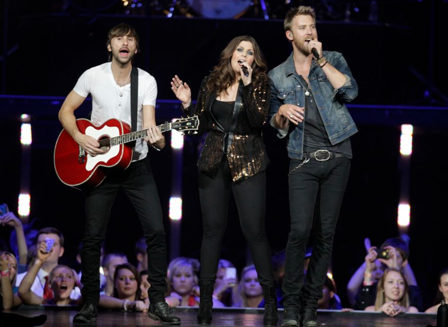 **FILE** Lady Antebellum's Charles Kelly (left), Dave Haywood (right) and Hillary Scott perform May 16, 2012, in Louisville, Ky. (Associated Press)