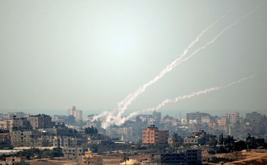 Smoke trails from a rocket fired by Palestinian militants from the Gaza Strip toward Israel on Wednesday. Gaza militants pummeled southern Israel with dozens of rockets and mortars on Wednesday, and Israeli airstrikes killed two Palestinians. (The Associated Press)