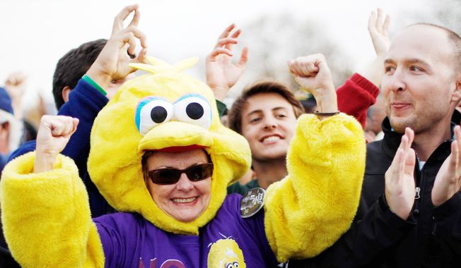A backer of President Obama shows her support by dressing in a Big Bird costume to cheer during a campaign event at City Park in Denver on Wednesday. (Associated Press)