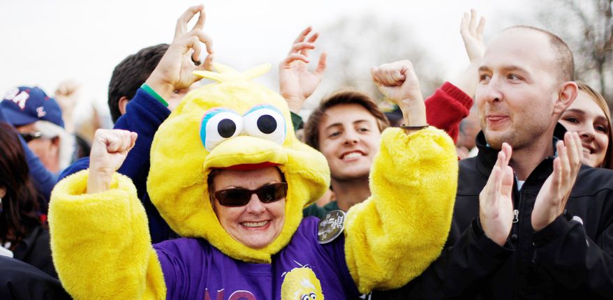 A backer of President Obama shows her support by dressing in a Big Bird costume to cheer during a campaign event at City Park in Denver on Wednesday. (Associated Press)