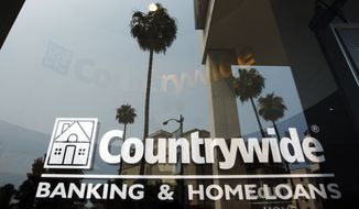 **FILE** Buildings and palm trees are reflected on the entrance of the Countrywide Financial Corp. office in Beverly Hills, Calif., on June 25, 2008. (Associated Press)