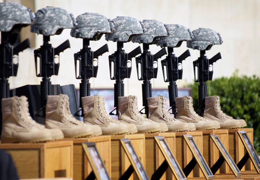 A memorial to victims of the Fort Hood shooting is shown on Nov. 10, 2009, before the start of a memorial service attended by President Obama at Fort Hood, Texas. (AP Photo/Donna McWilliam)