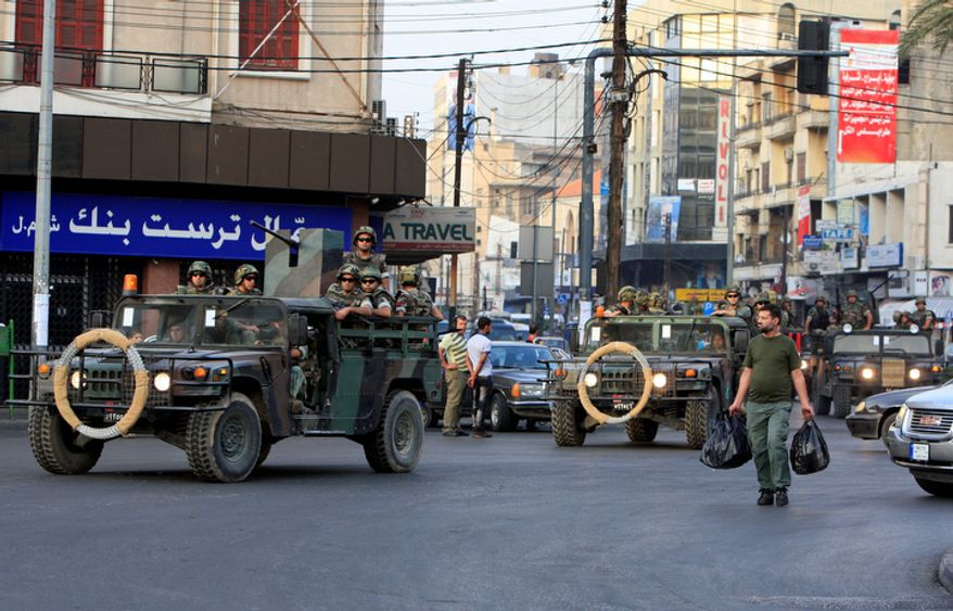 Lebanese Army soldiers patrol Oct. 22, 2012, in the northern port city of Tripoli, Lebanon, during clashes that erupted between supporters and opponents of the Syrian regime. Lebanese troops launched a major security operation to open all roads and force gunmen off the streets, trying to contain an outburst of violence set off by the assassination of a top intelligence official who was a powerful opponent of Syria. (Associated Press)