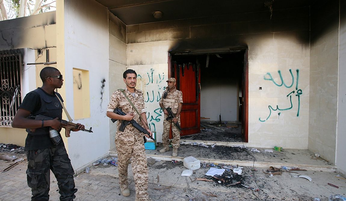 ** FILE ** Libyan military guards check one of the burned-out buildings at the U.S. Consulate in Benghazi, Libya, on Saturday, Sept. 14, 2012, during a visit by Libyan President Mohammed el-Megarif to express sympathy for the death of J. Christopher Stevens, the U.S. ambassador to Libya, and his colleagues in the Sept. 11 attack on the consulate. (Associated Press)