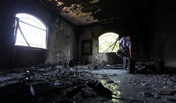 A Libyan man investigates the inside of the U.S. Consulate in Benghazi, Libya, on Thursday, Sept. 13, 2012, after an attack that killed four Americans, including Ambassador J. Christopher Stevens, two days before. (Associated Press)