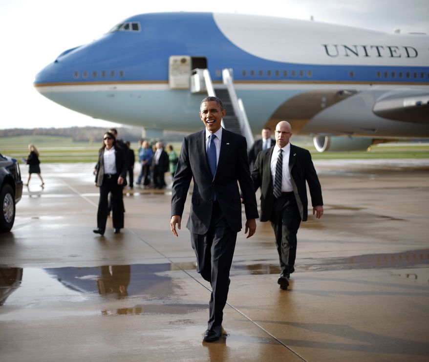 President Obama walks Oct. 24, 2012, across the tarmac to greet supporters upon his arrival on Air Force One at the Quad Cities International Airport in Moline, Ill., as the president began a two-day campaign blitz, through eight states with stops in key battleground areas of Iowa, Colorado, Nevada, Ohio and Virginia. (Associated Press)