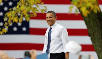 ** FILE ** President Obama smiles as he arrives at a campaign stop on Oct. 24, 2012, at The Mississippi Valley Fairgrounds in Davenport, Iowa. The president began a two-day campaign blitz through eight states with stops in key battleground states Iowa, Colorado, Nevada, Ohio and Virginia. (Associated Press)