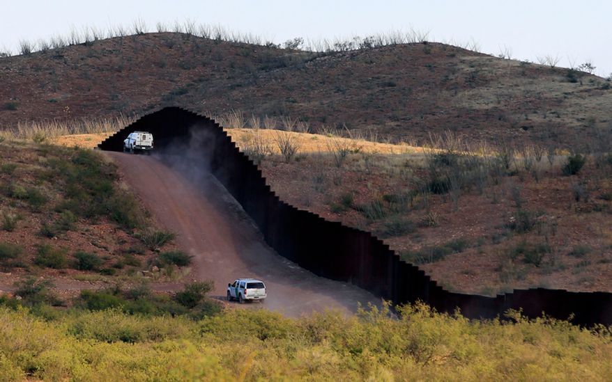 U.S. Border Patrol agents patrol the border fence in Naco, Ariz., on Tuesday, Oct. 2, 2012, near where Agent Nicholas Ivie was shot and killed and one other was shot and injured. (Associated Press)