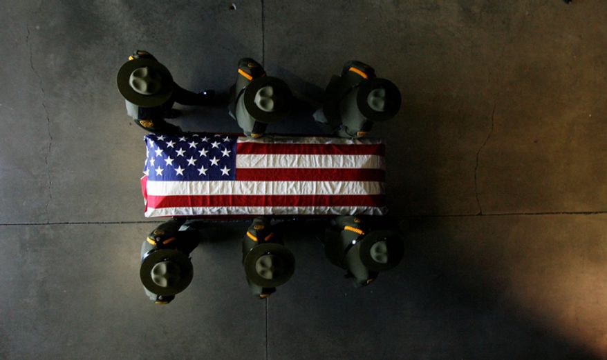 Border patrol agents carry the casket of agent Nicholas Ivie during his funeral at the UCCU Center at Utah Valley University in Orem, Utah, on Oct. 11, 2012. Ivie, a Provo, Utah, native, was killed Oct. 2 in a shooting at the Arizona-Mexico border. (Associated Press/The Salt Lake Tribune)