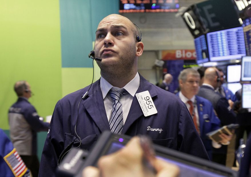Trader Daniel Chiarmonte works on the floor of the New York Stock Exchange on Wednesday, Oct. 24, 2012. (AP Photo/Richard Drew)