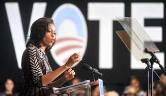 First lady Michelle Obama talks about getting out the vote during a campaign rally in Oct. 19 in Racine, Wis. About 2,500 people gathered to see her speak at Memorial Hall. (Journal Times via Associated Press)