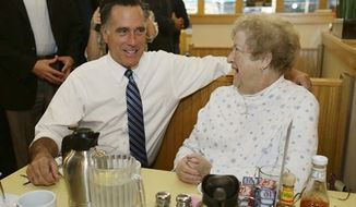 Republican presidential candidate, former Massachusetts Gov. Mitt Romney sits and talks to a customer as he makes an unscheduled stop at First Watch cafe in Cincinnati, Ohio, Thursday, Oct. 25, 2012. (AP Photo/Charles Dharapak)