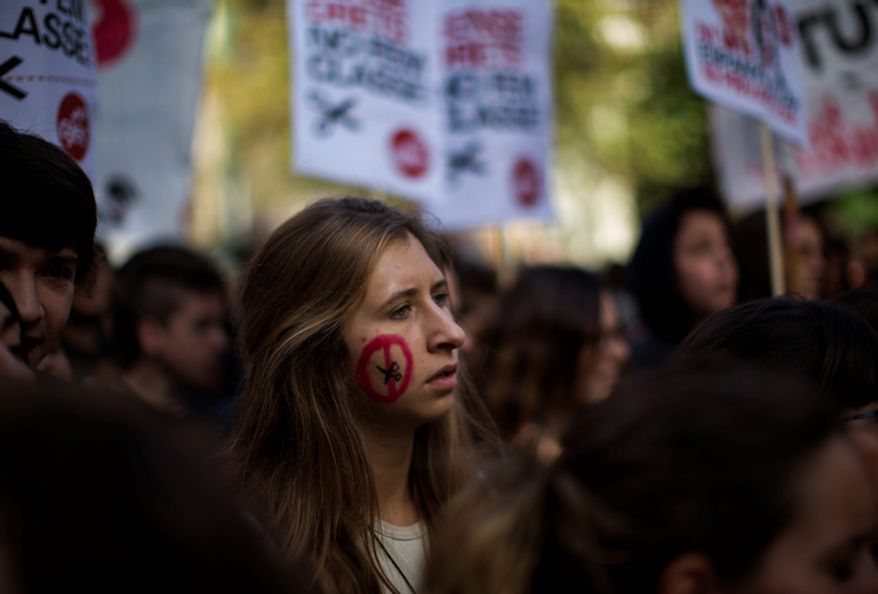 Students march in protest against government cuts in education in Barcelona on Wednesday, Oct. 17, 2012. The Spanish government has pushed through nine straight months of tough austerity measures that have prompted Spain's 17 regional governments, some of which are heavily indebted, to slash spending in health care and education. (AP Photo/Emilio Morenatti)
