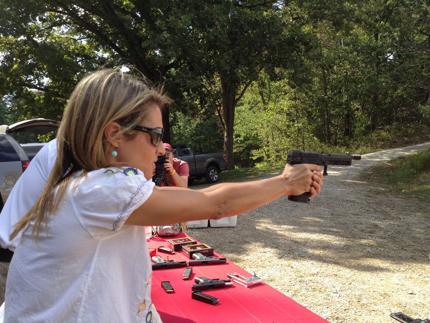 Emily Miller shooting a .22 caliber pistol.